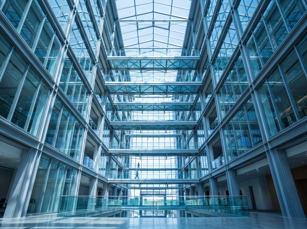 A spacious glass-roofed office atrium.